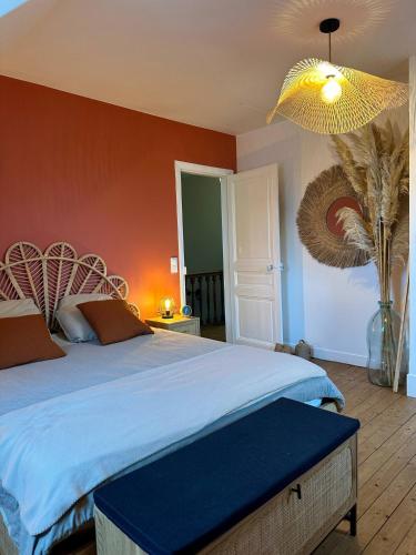 ein Schlafzimmer mit einem Bett mit einer blauen Bettdecke in der Unterkunft Le Magnolia Maison 12 Couchages in Dieppe