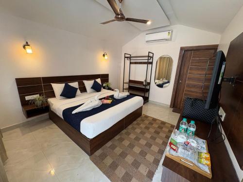 a bedroom with a bed and a flat screen tv at Glampers Resort Rishikesh at River Side in Rishīkesh