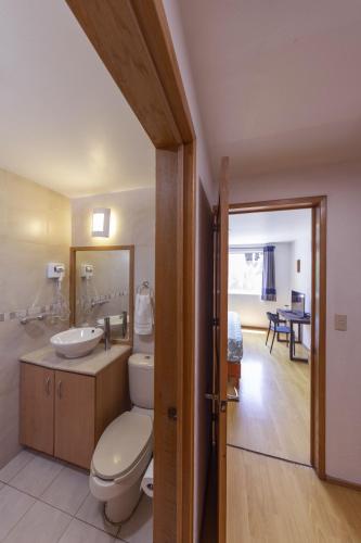 a bathroom with a toilet and a sink at Casa Hidalgo By Mi Querido Coyoacán in Mexico City