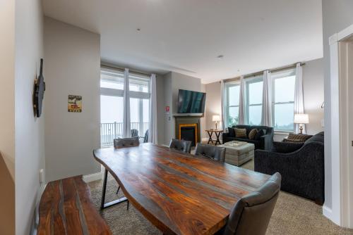 a living room with a wooden table and a couch at Snowshoe Village Ski-in - Ski-out Condo w Hot Tub in Snowshoe