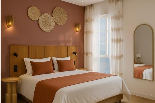 a bedroom with a large bed and a window at Hôtel de l'Horloge in Avignon