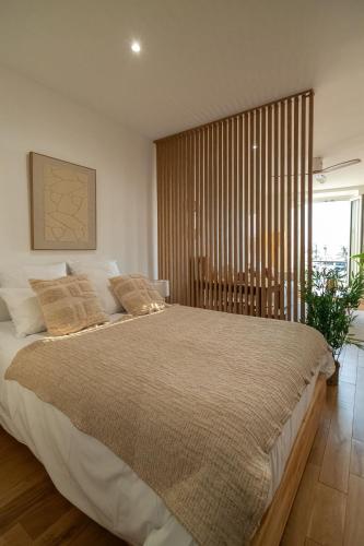 ein Schlafzimmer mit einem großen Bett mit einem großen Fenster in der Unterkunft Casa Sana - Escapade sur le Port de Sanary - Wi-Fi in Sanary-sur-Mer