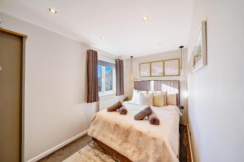a bedroom with a bed with two pillows on it at Two Bed Home in Portishead in Portishead
