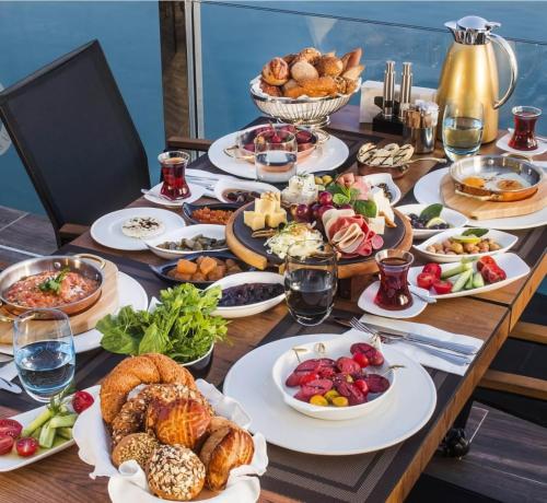 a table with many plates of food on it at Nexus By Taksim Hotel in Istanbul