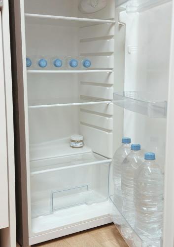a refrigerator filled with lots of bottles of water at Dazzlday in Seoul