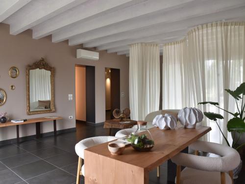 a dining room with a wooden table and chairs at Domus Natura, un'oasi verde tra Padova e Venezia in Vigonza