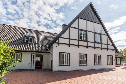 a white house with a black roof at Coffee Fellows Hotel Siegburg West in Siegburg