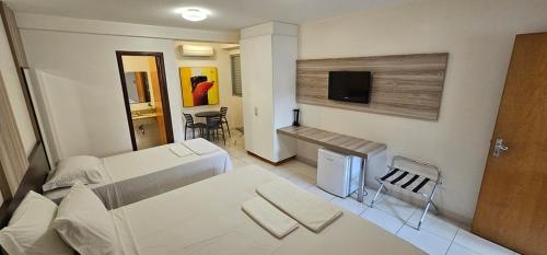 Ένα ή περισσότερα κρεβάτια σε δωμάτιο στο Executivo Hotel