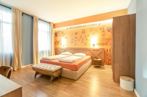 a bedroom with a bed and a wall with a poster at 1 BR Wine Journey in Sofia