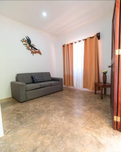 a living room with a couch and a table at Buddha Retreat Hotel in San Juanillo