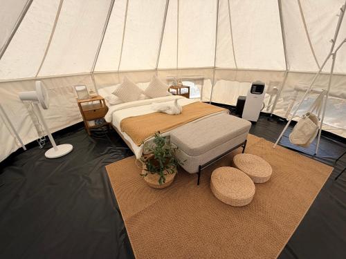 a bedroom with a bed in a tent at L'camp and cafe' Kohchang in Trat