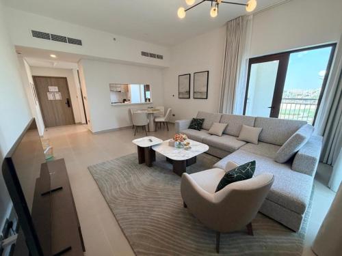 a living room with a couch and a table at 1BR Yas Golf Collection, short walk to Water Park in Abu Dhabi