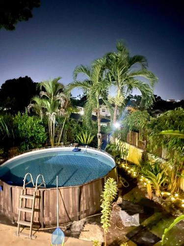 a swimming pool with a ladder and palm trees at Harbor View - 4bd By ZenBreak in Saint Michael