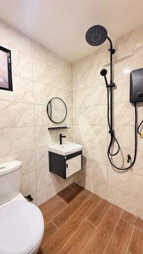 a bathroom with a shower and a toilet and a sink at Me'Lawwa Studio -Private Pool- in Kampung Padang Masirat