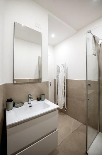 a bathroom with a sink and a mirror at PrimeLoft Cathedral-Panoramic Suite in Ferrara