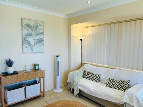 a living room with a white couch and a table at Pet friendly home near Adventure World Fiona Murdoch in Perth