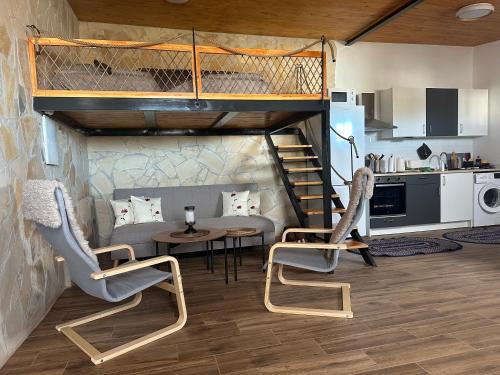 a loft bed in a room with a table and chairs at Casita Esperanza in Santa Catalina