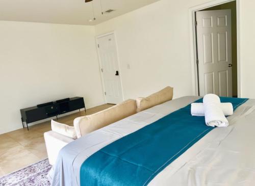 a bedroom with a large bed with blue and white sheets at Cozy Private Room in Milton near Beaches in Milton