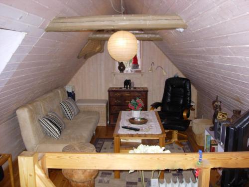 a living room with a couch and a table at Travel back in time in Nyord