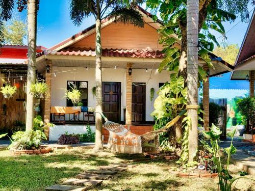 a house with a hammock in front of it at Naraya Resort in Ko Lanta