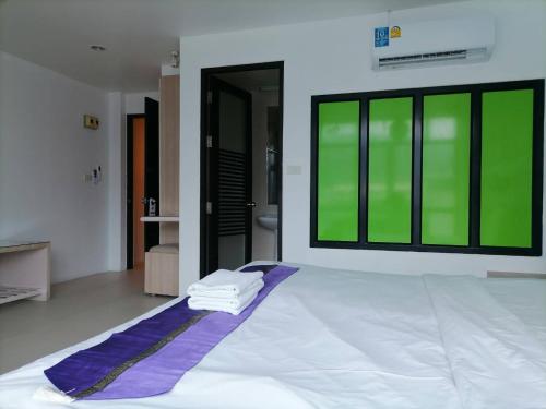 a bed in a room with a large window at AtWhitePatong in Patong Beach
