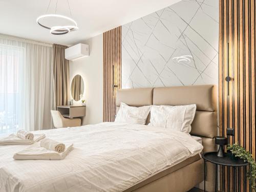a bedroom with a large bed with white sheets at Skyline Serenity Modern Apartment with Terrace by Flat Manаger in Plovdiv