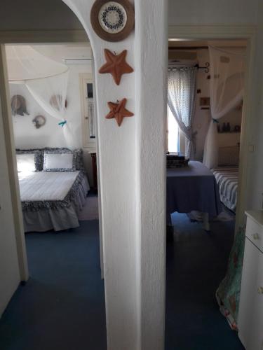 a bedroom with two beds and two stars on the wall at Exclusive Beach House in Gavrion