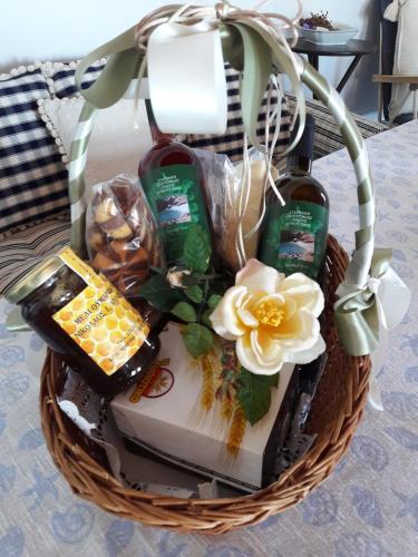 a basket filled with food and drinks and a flower at Exclusive Beach House in Gavrion