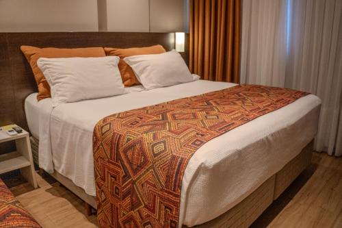 Ένα ή περισσότερα κρεβάτια σε δωμάτιο στο Hotel Plaza Camboriú