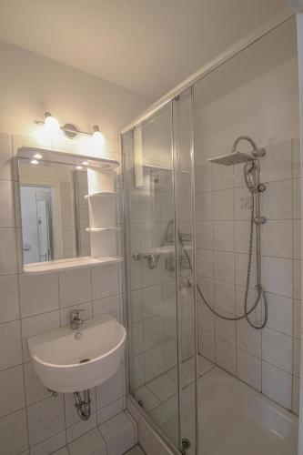 a bathroom with a shower and a sink and a shower at Vier Jahreszeiten 2-52 in Großenbrode