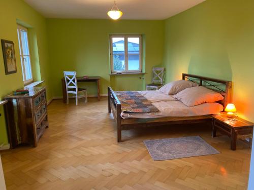 a bedroom with a bed and a table and a desk at Villa Art Residence Überlingen in Überlingen