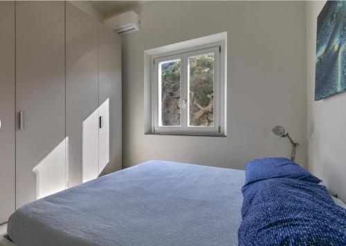 Ένα ή περισσότερα κρεβάτια σε δωμάτιο στο Bilocale Capraia - terrazza vista mare