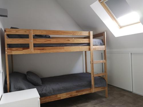 a couple of bunk beds in a room at Gites et camping le Sédour in Riom-ès-Montagnes