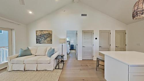 a living room with a couch and a table at Crystal Blue Persuasion in Santa Rosa Beach