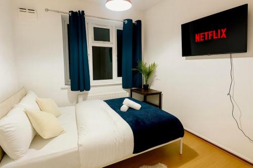 a living room with a white couch and a window at East London Suites in London