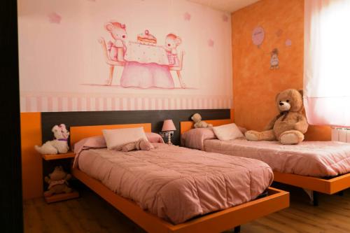 two beds in a childs bedroom with stuffed animals at Villa close to the center w pool garden H30 in Begur
