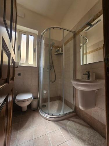 a bathroom with a shower and a toilet and a sink at Salty Sun Seafront Penthouse in Marsalforn