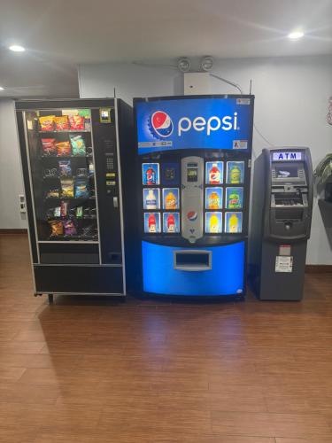 a pepsi machine next to a soda machine at Days Inn by Wyndham Brooklyn Borough Park in Brooklyn