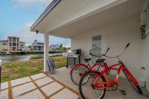 a red bike parked next to a house with a stove at Oyster House Waterfront 3b2b Kayaks BBQ Games in Hernando Beach