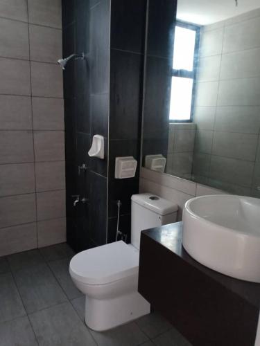 a bathroom with a white toilet and a sink at DHome Laksamana Melaka in Malacca