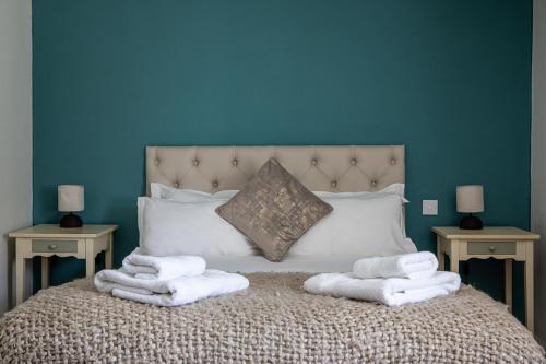 a bedroom with a bed with towels on it at Bathurst Arms in Cirencester