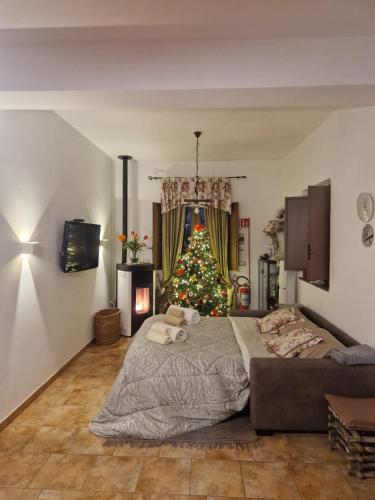 a bedroom with a christmas tree and a bed at La casa di Giulia in Bronte