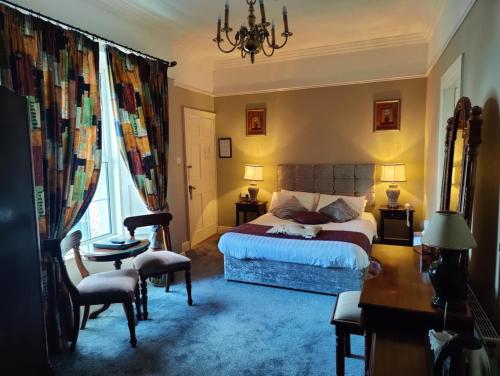 a hotel room with a bed and a desk and a desk at Townsend House Guest House in Birr