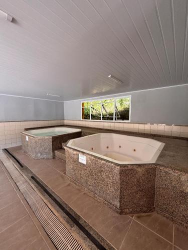 a large bathroom with two large jacuzzi tub at Refúgio em Angra com Praia Privativa in Angra dos Reis