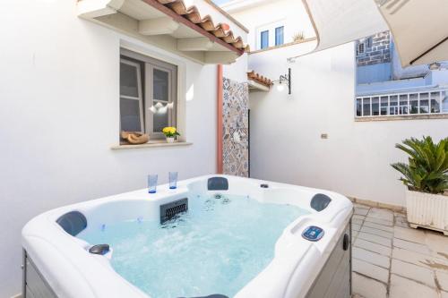 a jacuzzi tub in the middle of a patio at Giardino dellorologio - Salento Reservation in Racale