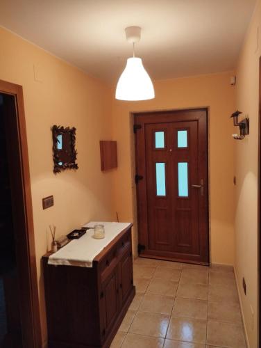 a kitchen with a wooden door and a counter top at Casa Alicia in Carnota