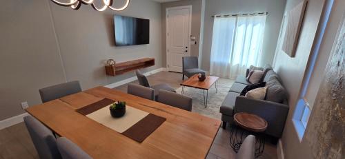 a living room with a dining room table and a couch at Lux Modern 3BR - 2BA Duplex Brand New Furnished in Brownsville