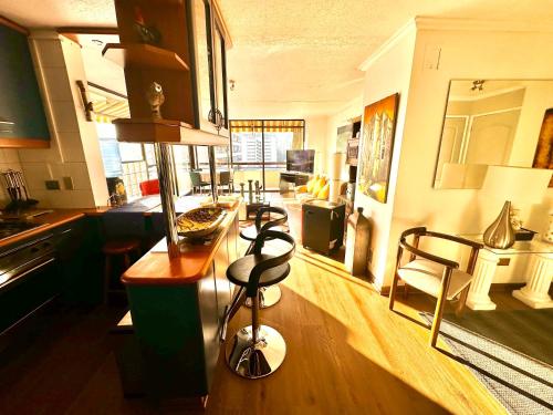 a kitchen with a table and chairs in a room at sanhatan in Santiago