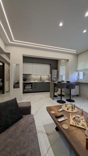 a living room with a couch and a table at K & V apartments in Amfiklia