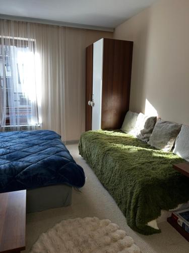 a bedroom with two beds and a window at Green Point Studio O12 in Chepelare